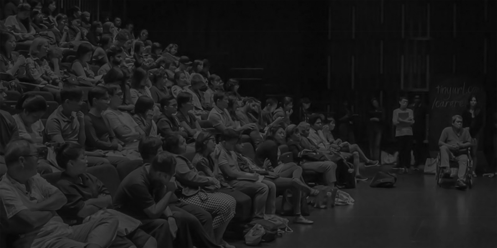 Black and white image of a packed auditorium